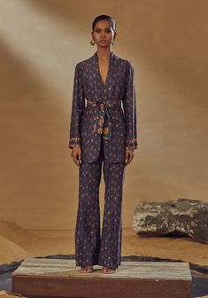 Editor's Note Printed Pantsuit With A Contrast Print Belt Fabric: Dupion Silk, Lining: Crepe Color: Blue Embroidery Details: Hand Embroidery (dori Work, Mirrors, Anchor Threads, Sequins, Zardoz... Pant Suit For Women, Indian Wardrobe, Silk Pant Suit, Edgy Woman, Dori Work, Pant Suits For Women, Anchor Threads, Print Pant, Floral Print Pants