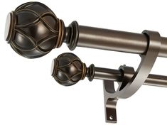 a pair of curtain rods with decorative knobs on each rod, and an ornate ball finial