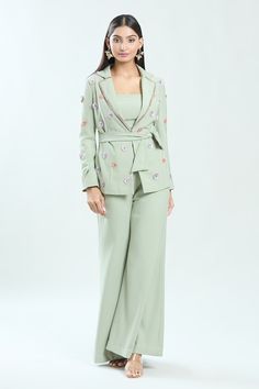 Sage green blazer featuring floral sequin hand embroidery in the front and sleeves. Paired wit a flared solid pant. - Aza Fashions Embellished Sets For Workwear, Fitted Embellished Sets For Workwear, Embellished Fitted Sets For Workwear, Fitted Workwear Sets With Floral Embroidery, Fitted Floral Embroidery Sets For Workwear, Floral Embroidery Pants For Spring Party, Fitted Floral Embroidery Sets For Work, Fitted Sets With Floral Embroidery For Work, Floral Embroidered Party Pants For Spring