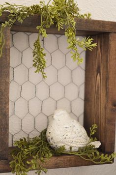 a white bird sitting on top of a wooden shelf