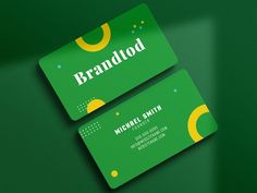 two green business cards sitting on top of each other with the word brandlod printed on them