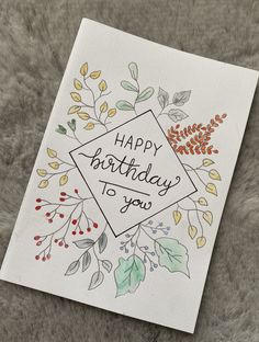 a happy birthday card with leaves and berries on the front, which reads happy birthday to you