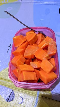 a pink bowl filled with cut up carrots