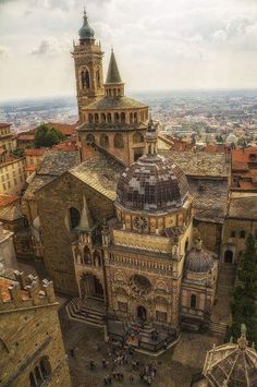 an aerial view of a church in the middle of a city with lots of tall buildings