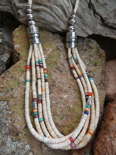 This is a beautiful Handcrafted Native American Made Multi strand Heishi necklace. Each necklace is entirely Handcrafted which makes it a ONE OF A KIND you get the exact necklace shown in the pictures. The necklaces that I sell are meticulously crafted by Native American bead workers, and the quality and attention to detail is truly exceptional. The necklace measures about 30" (end to end) bead length is 27" it has a Sterling Silver toggle clasp closer.  It has five wonderful strands that have a beautiful mix of colors.   With all the colorful gemstones it will be sure to match almost any outfit.  The Multi Colored mix of Gemstones and the hand stamped Sterling Silver beads add a very rich look to this work of art. I personal own one of these and it is my favorite necklace the colors are s Southwestern Multi-strand Colorful Beads Jewelry, Southwestern Multi-strand Jewelry With Colorful Beads, Bohemian Single Strand Round Jewelry, Southwestern Multi-strand Polished Bead Necklaces, White Multi-strand Jewelry With Natural Stones, Traditional White Necklaces With Natural Stones, Artisan Lariat Jewelry With Colorful Beads, Artisan Lariat Necklace With Colorful Beads, Artisan White Gemstone Beads Necklaces