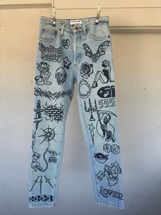 "This up-cycled American Apparel DIY denim is a one of a kind piece. All graphics are hand drawn with permanent fabric pen. The jeans have been washed with all natural detergent and steamed to ensure cleanliness of each sustainably thrifted item. All of my pieces in the store have been pre-loved, so there may be markings that add to the charm of the restored piece. Recommended to steam or wash with cold water to prevent possible fading of ink.  Measurements: Waist 29\", Inseam 28\"" Doodle On Clothes, Fabric Painting Aesthetic, Diy Painting Jeans, Sharpie Pants, Aesthetic Painted Jeans, Jeans Drawing Diy, Jeans With Drawings, Old Pants Diy Upcycle, Denim Art Painting