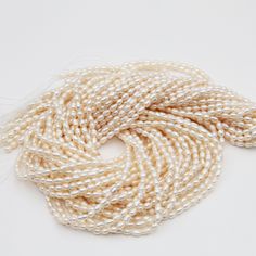 three strands of white pearls on a white background