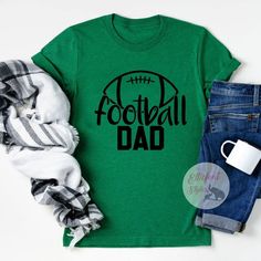 Proud Football Dad. The perfect dad shirt to wear for game day, practice, or out and about! Show your player who their biggest fan is. Express your style with our range of cool printed t-shirts and graphic tees. Dad Fashion, Sports Shirt, Printed T Shirts, Out And About, Mom Shirt, Dad To Be Shirts, Sport T Shirt, Sports Shirts, Mom Shirts