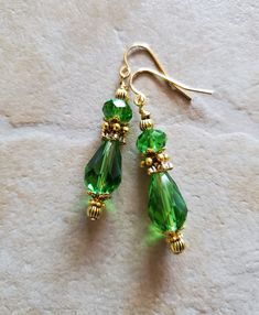 Gorgeous, very large green crystal, teardrop, stainless steel hook earrings. Earrings are perfect to wear for any occasion.  Each earring has one large green crystal teardrop, one green crystal rondelle, antiqued gold tone findings, suspended from gold plated, stainless steel hook ear wires.   Earrings measure 1 7/8 inches long from the top of the earring hook to the bottom of the earring. **These are large earrings. Copyright © Busy Bee Bumble Beads 2006-2021. All Rights Reserved. No part of this website may be reproduced. They are designed and created by me, Busy Bee Bumble Beads. Design updated Oct 8, 2021 REFERENCE #TEG104 Green Nickel-free Teardrop Drop Earrings, Green Teardrop Drop Earrings Nickel Free, Green Nickel-free Teardrop Earrings, Green Dangle Crystal Earrings For Gift, Nickel-free Green Teardrop Pendant Earrings, Elegant Green Crystal Earrings With Ear Wire, Teardrop Earrings For May Birthstone Gift, Nickel-free Green Drop Crystal Earrings, Green Crystal Drop Earrings For Gift