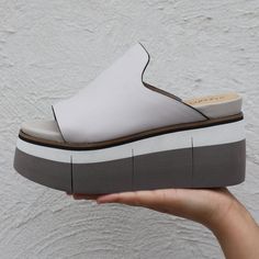 Slide in to the effortless direction of Flow in mist. This soft leather sandal features an uncomplicated silhouette, designed to fit simply into an affluent wardrobe of modern style. The multi tone lightweight platform gives it a subtle athleisure twist while maintaining its enchanting boho style. Features:- Women's slip-on sandal- Crafted with genuine leather- Inked leather edges- Luxury athleisure and boho style- Foam padded sock- 2.87" Layered EVA sole with flex grooves- 1.97" PlatformBy Nake Luxury Athleisure, Soft Leather Sandals, J Cole, Flats Shoes, Eva Sole, Slide In, Summer Sandals, Shoes Womens, Heeled Sandals