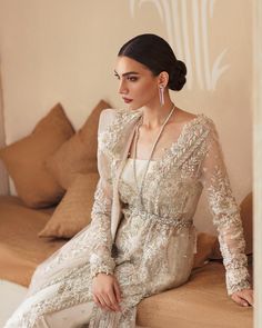 Elegant Pakistani Wedding Dress in Sharara Kameez Style is a breathtaking attire that gives you a dreamy appearance on a big day. Floral designs, embroidery, crystals, and cut-dana details make this stunning Pakistani Dress an epitome of beauty and your priority for the wedding. Kameez: The long kameez in premium organza fabric is gracefully emblazoned with lavish embroidery work. Traditional floral designs and threads give an elegant touch to the kameez. Cut-dana, pearls, crystals, and sequins Pakistani Dresses Wedding, Embroidery Crystals, Kameez Style, Long Kameez, Latest Pakistani Dresses, Pakistani Designer Clothes, Wedding Festivities, Pakistani Wedding Dress, Pakistani Dress