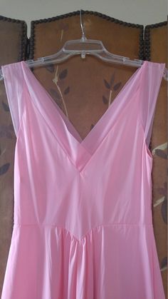 "70s gorgeous bubblegum pink nylon maxi slip / nightie by Vanity fair. The bust has delicate embroidered flower detail. Waist is accentuated with a deep V and a maxi length skirt part. Sheer hem and shoulder straps. **just very light 'scratch' marks on bottom of skirt but barely visible** Size 36 Nylon Length 55\", waist 28\" Made by vanity fair" V-neck Maxi Dress For Wedding Night In Spring, Spring Pink Dress With Sheer Bodice, Summer Pink Maxi Dress With Lined Bodice, Pink Maxi Dress With Lined Bodice For Summer, Pink Maxi Dress With Sheer Bodice, Pink Lined Bodice Maxi Dress For Summer, Spring Wedding Night V-neck Maxi Dress, Sleeveless Pink Maxi Dress With Lined Bodice, Summer V-neck Maxi Dress For Wedding Night