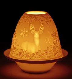 a light that is sitting on top of a table with a deer in it's head