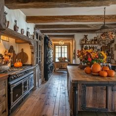 an old fashioned kitchen with wooden floors and walls