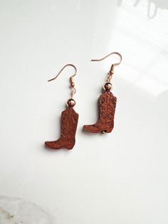 OVERVIEW **These earrings are made with wooden cowboy boot beads, 4mm rose gold beads, set on rose gold/copper ear wires, for pierced ears. ** Custom designed and made in USA. LOOKING FOR EARRINGS? More styles can be found here: https://www.etsy.com/shop/CarbonAndCopper?ref=hdr§ion_id=18041289 SHIPMENT & DELIVERY **All jewelry comes in a custom linen bag and shipped in a padded envelope. **These are ready made and ready to be shipped to you within 1-3 days of purchase. **Domestic Shipping is app Nickel-free Western Style Earrings, Nickel-free Adjustable Western Earrings, Adjustable Nickel-free Western Earrings, Western Style Earrings For Gifts, Cowboy Boot Earrings, Cowgirl Earrings, Boot Earrings, Girl Earrings, Rose Gold Beads