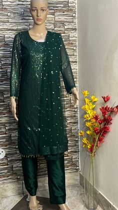 This green sequin straight kurta is made from designer sequin fabric which is eye catching in its look. This is kurta plazzo set .it is paired up with silk plazzo . Both the kurta and pants will have lining inside. We will collect your measurements as soon as the outfit is booked. Please feel free to contact us on etsy convo for further queries. Thank you Dark Green Sequin Party Dress, Party Churidar In Shantoon, Semi-stitched, Green Resham Embroidered Georgette Kurta, Dark Green Traditional Wear With Dupatta For Eid, Designer Green Salwar Kameez With Mirror Work, Green Anarkali Unstitched Suit In Georgette, Green Chinon Sharara With Mirror Work, Party Wear Long Sleeve Kurta With Mirror Work, Party Wear Kurta With Mirror Work