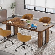 a wooden table with four chairs and a laptop on it, in an office setting