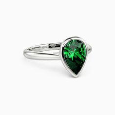 a green heart shaped ring on a white background