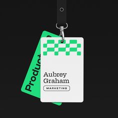 a green and white luggage tag attached to a lanyard with the words aulbrey graham on it