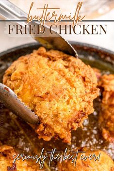 fried chicken is being served in a skillet with a spatula on the side