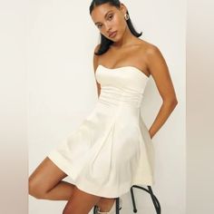 Reformation Mini Dress. Perfect For Engagement Photos Or Rehearsal Dinner. White Fitted A-line Strapless Dress, Fitted Bodice Mini Dress For Summer Banquet, Summer Banquet Mini Dress With Fitted Bodice, Classic A-line Dress For Date Night, Chic Cream Dress For Banquet, White A-line Strapless Cocktail Dress, Lined Mini Dress For Wedding, Off White Satin Summer Dress, Wedding Mini Dress Lined