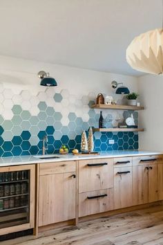 a kitchen with blue hexagonal tiles on the wall