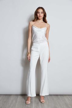 We chose our favorite Fluid Crepe for the season's must have pant. Incredibly flattering with a fit & flare leg - these pants are detailed with a partially lined lace insert down the sides for a glimpse of leg. Get ready for the compliments. Elie Tahari Exclusive Fit & Flare Fluid Crepe Pant with Lace Side Stripes 70% Triacetate, 30% Polyester Runs true to size. Model is 5'9" and wearing size 2 Measurements: 10"L front rise 33.5"L inseam (approx. length for a size 6) Dry Clean Only Imported Styl Elegant Flare Dress Pants For Evening, Elegant Fitted Flare Pants, Fitted Bias Cut Bottoms For Night Out, Elegant Stretch Flare Pants, Fitted Party Bottoms With Bias Cut, Elegant Elastane Pants For Party, Elegant Stretch Wide Leg Flare Pants, Elegant Flared Wide Leg Party Pants, Elegant Flare Wide Leg Pants For Party