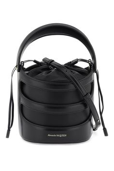 The Rise bucket bag by Alexander McQueen is made of leather with a structured Harness-style cage and a soft nappa pouch. It features a drawstring closure, a leather interior, and an adjustable and removable shoulder strap. The metallic accessories have a gold finish. Harness Style, Metallic Accessories, Metal Accessories, Leather Bucket Bag, Leather Bucket, The Rise, Leather Interior, Business Fashion, Leather Fashion