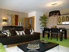 a living room filled with furniture and a dining table in front of a mirror on the wall