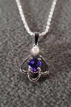 I am offering you this truly exquisite vintage unique genuine combination round and oval shaped prong set African amethyst and cultured pearl stones done in a dimensional curved scrolled design shaped , on a necklace chain. What a spectacular design.... So very elegant and a very fancy ornate setting. It is measuring a bit under 1 inch by app. 1/2 inch, you will be noticed when wearing this lavaliere necklace. The necklace chain is a very sturdy rolled rope link chain that measures a very versat Elegant Purple Oval Pendant Necklace, Purple Oval Jewelry For Formal Occasions, White Gold Oval Pearl Pendant Jewelry, Vintage Purple Oval Cabochon Jewelry, Purple Oval Pendant Necklace For Anniversary, Pearl Pendant Oval Jewelry For Anniversary, Oval Pearl Pendant Jewelry For Anniversary, Elegant Oval Amethyst Pendant Jewelry, Oval Purple Necklace For Anniversary