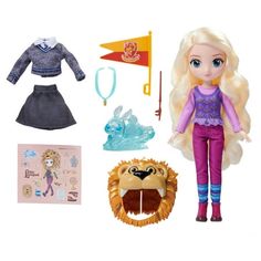 a doll with blonde hair and purple outfit next to other items on a white background