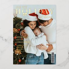 a magazine cover with a man and woman holding a baby in front of a christmas tree