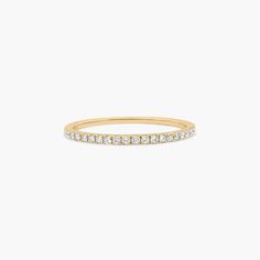 a yellow gold band with white diamonds