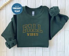 Fall Vibes Sweatshirt, Boo Embroidered Halloween Sweatshirt | Spooky Season Fun Fall Crewneck Sweater | Autumn Pullover  ABOUT US: --------------- ✔  Looking for a personalized, comfortable, and soft sweatshirt/hoodie? Then you can express yourself with our products! From color and size to unique designs, we have everything you need to create a sweatshirt/hoodie that perfectly represents you. If you have any questions, don't hesitate to contact us and we'll get back to you as soon as possible. H Varsity T-shirt With Embroidered Graphics For Fall, Fall School Spirit T-shirt With Letter Embroidery, School Spirit T-shirt With Letter Embroidery For Fall, Fall School Spirit Embroidered Sweatshirt, Fall College Sweatshirt With Embroidered Text, College Fall Sweatshirt With Embroidered Text, Fall School Spirit Sweatshirt With Embroidered Graphics, Embroidered Fall College T-shirt, Fall T-shirt With Embroidered Graphics For School Spirit