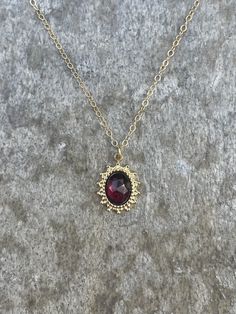 This necklace is handcrafted with an authentic 6x8mm garnet stone in a 16x11mm gold-plated stainless steel setting. The chain is 14k gold-filled and will not tarnish easily. The stone is AAA quality. This necklace is hypoallergenic. (Cadium free, lead free, and nickel safe) Garnet is an energizing stone that promotes passion and love.  The necklace comes in a ribbon-wrapped box, ready to be gifted. If you would like to leave a note for the recipient, you can do so during checkout. Elegant Ruby Birthstone Necklace In Gold, Elegant Gold Ruby Birthstone Necklace, Elegant Gold Jewelry With Garnet, Elegant Gold Garnet Jewelry, Gold Jewelry With Garnet Birthstone, Gold Garnet Gemstone Jewelry, Gold Garnet Birthstone Jewelry, Gold Garnet Jewelry With Birthstone, Yellow Gold Garnet Necklaces With Oval Shape