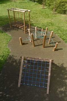 an aerial view of a playground with swings and climbing bars in the ground, surrounded by grass