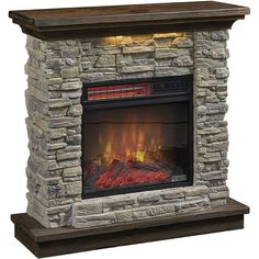 a stone fireplace with an electric fire in the center and logs on either side, against a white background