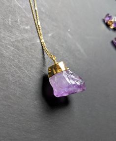 Raw amethyst is a classic in the world of gemstones. It is one of the more affordable stones with the most vibrant natural spectrum of purple tones. I have this necklace in both tiny crystals and large crystals, and a few different chain lengths 💟 **This listing is for only one necklace Each large crystal pendant measures approximately 1 inch in length.💜 Each small amethyst measures between 1/4 and 1/2 inch in length 💜 The chain for ThIs necklace measures 18 inches in length. You can purchase Purple Necklace With Large Stone For Gift, Gold Amethyst Crystal Necklace, Faceted, Gold Amethyst Necklace With Raw Stone, Spiritual Amethyst Jewelry With Raw Stone, Purple Amethyst Pendant Crystal Necklace, Gold Amethyst Crystal Necklace For Healing, Amethyst Jewelry With Raw Stone For Healing, Amethyst Raw Stone Crystals For Gift, Healing Amethyst Jewelry With Raw Stone