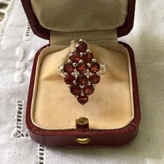 French VINTAGE ART DECO ELEGANT MARQUISE STERLING SILVER AND GARNET RING. MAGNIFICENT VINTAGE DESIGN, THE DESIGNER RING, IN THE SHAPE OF A DIAMOND, BEAUTIFUL ELEGANT SETTING IN STERLING SILVER. 12 GARNETS: 4 mm in diameter. TRAY DIMENSION: 24 x 13 mm. SIZE: 55. US SIZE: 7 1/8. WEIGHT: 4.0 gr. HALLMARK: 925. In very good shape. Box not included. Vintage Cluster Ring Suitable For Gifts, Collectible Cluster Gemstone Rings, Vintage Cluster Rings Hallmarked, Collectible Garnet Gemstone Ring, Antique Gemstone Cluster Ring As Gift, Antique Cluster Ring With Gemstone For Gift, Vintage Garnet Cluster Ring With Gemstone, Vintage Cluster Rings For Gifts, Vintage Cluster Rings As Gift