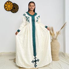 This elegant blue Ethiopian dress showcases gorgeous cultural designs with intricate patterns, reflecting the beauty of tradition. Perfect for any occasion, it combines cultural heritage with a modern flair, making it a stunning choice for everyday elegance. Key Features: Cultural Heritage: Adorned with exquisite handwoven details that honor Ethiopia's rich traditions. Flattering Design: The flowing silhouette ensures you look stunning at weddings, festivals, or any event where you want to shine. Ethical Craftsmanship: Handmade by skilled Ethiopian artisans, embracing tradition while making a bold fashion statement. Care Instructions: For best results, we recommend gentle hand washing. Shipping Information: Processing Time: 10 days Delivery: Shipping usually takes 3 to 5 days if you are in Cultural Design, Eritrean Dress, Ethiopian Dress, Habesha Kemis, Everyday Elegance, Cultural Heritage, Intricate Patterns, Bold Fashion, Ethiopia