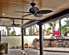 a dog is standing in the middle of an outdoor patio with ceiling fans on it