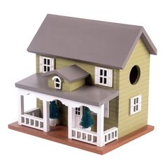 a doll house with a gray roof and white trim