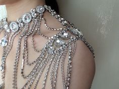 "Sparkle and Victorian style shoulder necklace featuring thousands of sparkle rhinestones crystals and linked with cable chains. We have also added an extra long cable chain with a sparkle pendant finished at end for you to adjust the length. Color: clear rhinestone crystals and glass stones Size: necklace measures around 0.9\" width and center dangly part measures around 4.75\" drop. Each side of the sparkle measures around 4.75\" long x 2.5\" width ** Please note we need to take around 5 days Glamorous Silver Body Jewelry For Wedding, Elegant Embellished Body Jewelry For Parties, Silver Wedding Body Jewelry With Sparkling Stones, Silver Body Jewelry With Sparkling Stones For Weddings, Glamorous Silver Crystal Body Jewelry, Silver Sparkling Stones Body Jewelry For Wedding, Silver Bling Body Jewelry For Wedding, Silver Backdrop Necklace With Sparkling Stones For Party, Silver Jeweled Body Jewelry For Wedding