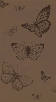 several butterflies flying in the air on a brown background with black and white ink drawings