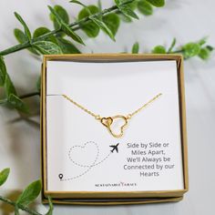 an open box with a necklace in it