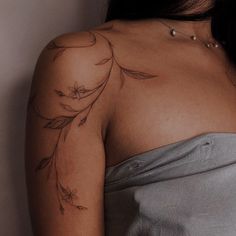 a woman with a tattoo on her shoulder