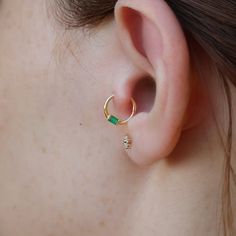 Cartilage Hoop Baguette Cut Emerald Clicker, 14K Gold Emerald Daith Earring, Emerald Helix Piercing, Emerald Daith Piercing, Single Earring This Product İs Made From 14K Solid Gold. You Can Prefer it For Cartilage,Daith,Conch,Helix Location.This is Preferation Who Have Smart Style. * Material: 14K Solid Gold (18K Available on Request) * Color Options: Yellow Gold, Rose Gold, White Gold * Stone: 100% Natural Emerald * Emerald Cut: Baguette * Total Emerald Carat: 0,07 * Inner Diameter Size : 8 mm * Shipped with Product Certificate * Listing for 1 pcs earring All of our jewelry is made from solid 14k yellow,white and rose gold.Because of using natural stone,the color of it may differ.All items in our store are 100 % handmade products. Indulge yourself and your loved ones to shine brightly wit Daith Earring, Daith Earrings, Cartilage Hoop, Daith Piercing, Helix Piercing, Gold Stone, Baguette Cut, Single Earring, Natural Emerald