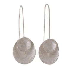 Balinese artisan Desi Antari designs a pair of drop earrings with a modern aesthetic. Crafted of sterling silver each earring features two complementary circular shapes that are crafted of sterling silver and given an etched texture that captures the light with magnificence. Modern Silver Round Disc Earrings, Elegant Silver Disc Earrings, Contemporary Silver Jewelry With Ear Wire, Modern Sterling Silver Round Disc Earrings, Paw Print Jewelry, Ribbon Jewelry, Printed Jewelry, Sterling Silver Drop Earrings, Earring Crafts