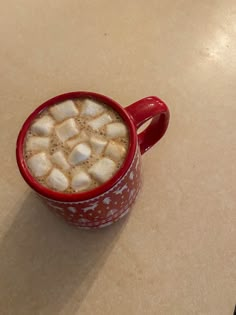 a red cup filled with hot chocolate and marshmallows