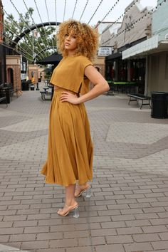 Look stylish in this gorgeous Jessica Crop and Midi Skirt Set. Crafted with a golden mustard color, the comfortable crop top and flowy midi skirt have an effortless casual look. Made of 80% polyester and 20% rayon, this set is perfect for any occasion. Spring Two-piece Crop Top With Short Sleeves, Two-piece Short Sleeve Crop Top For Spring, Spring Two-piece Short Sleeve Crop Top, Chic Summer Skirt Set With Short Sleeves, Two-piece Short Sleeve Crop Top For Summer, Chic Yellow Short Sleeve Crop Top, Casual Gold Skirt For Summer, Gold Midi Skirt For Summer, Gold Short Sleeve Midi Dress For Summer